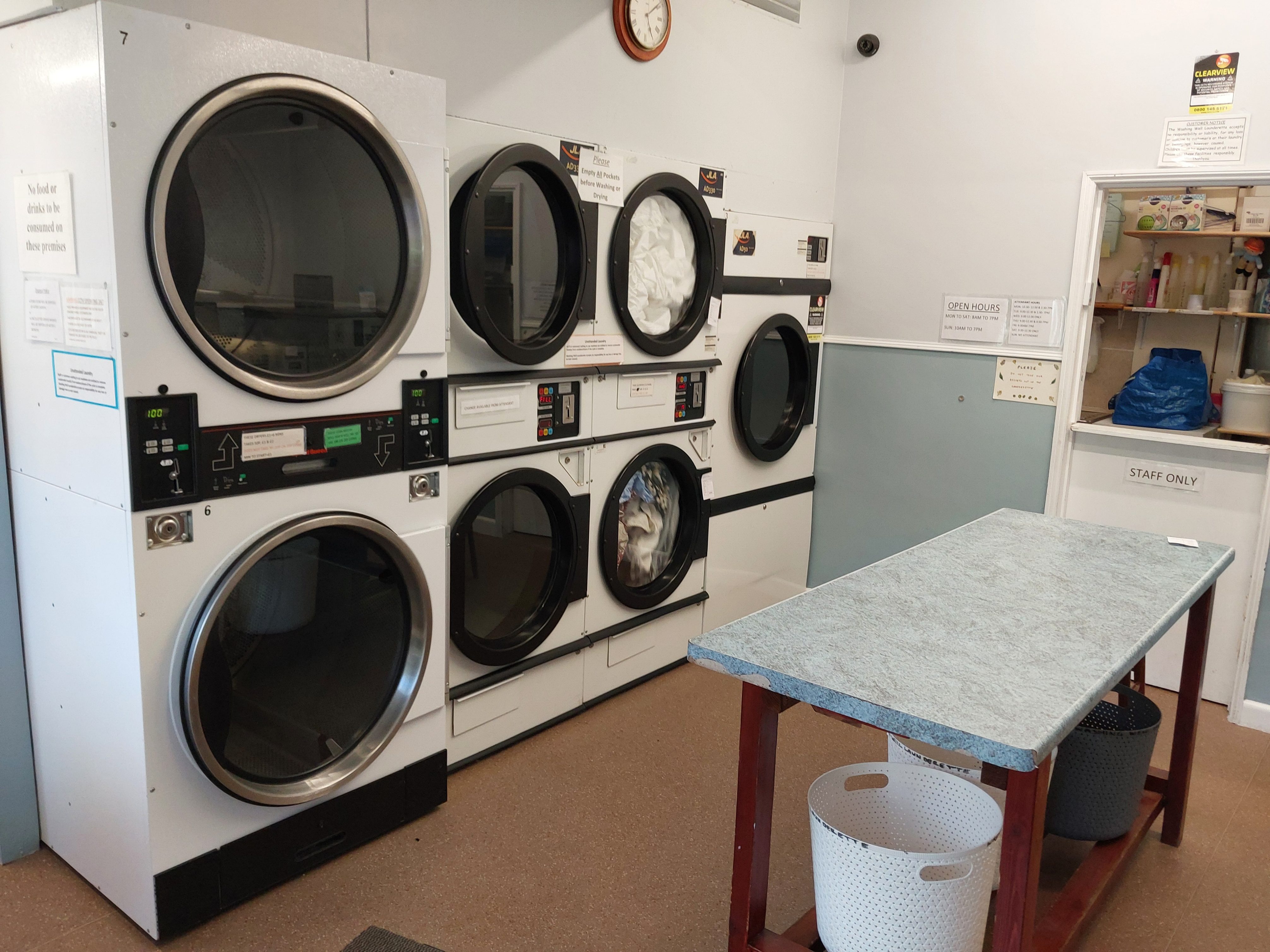 Commercial tumble dryers line at Washing Well Launderette Foxhole Paignton